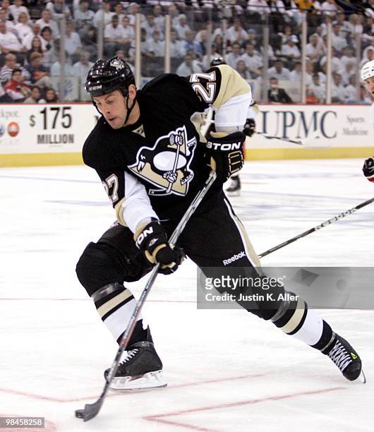 Craig Adams of the Pittsburgh Penguins shoots and scores against the Ottawa Senators in Game One of the Eastern Conference Quarterfinals during the...