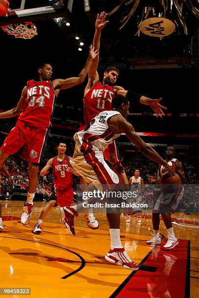 Mario Chalmers of the Miami Heat passes against the New Jersey Nets on April 14, 2010 at American Airlines Arena in Miami, Florida. NOTE TO USER:...