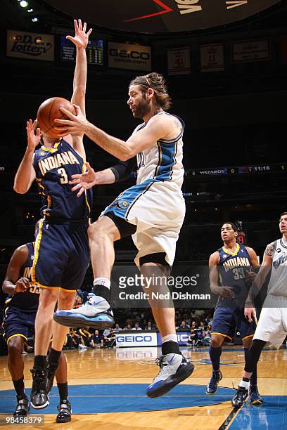 Fabricio Oberto of the Washington Wizards passes against Troy Murphy of the Indiana Pacers at the Verizon Center on April 14, 2010 in Washington, DC....