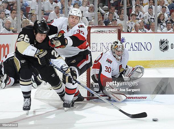 Ruslan Fedotenko of the Pittsburgh Penguins attempts a shot in front of Matt Carkner and Brian Elliott of the Ottawa Senators in Game One of the...