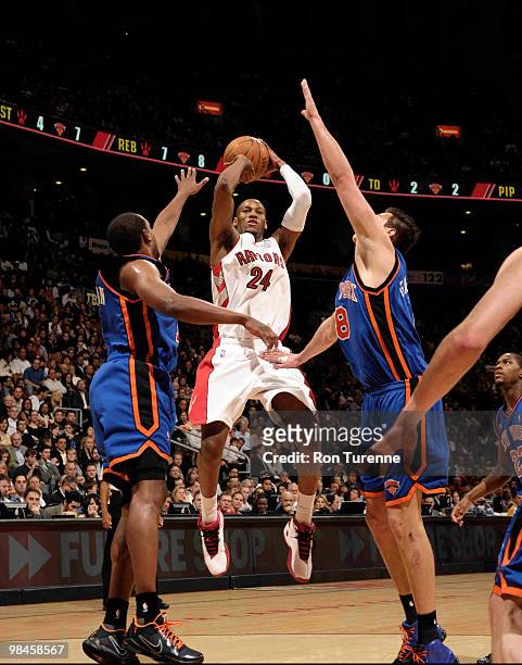Sonny Weems of the Toronto Raptors takes the mid-range jumper between Chris Duhon and Danilo Gallinari of the New York Knicks during a game on April...