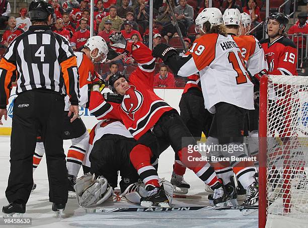 David Clarkson of the New Jersey Devils lands on top of Brian Boucher of the Philadelphia Flyers in Game One of the Eastern Conference Quarterfinals...