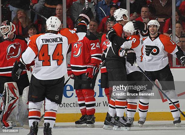 Chris Pronger of the Philadelphia Flyers is hugged by teammate Mike Richards following Pronger's second period goal against the New Jersey Devils in...
