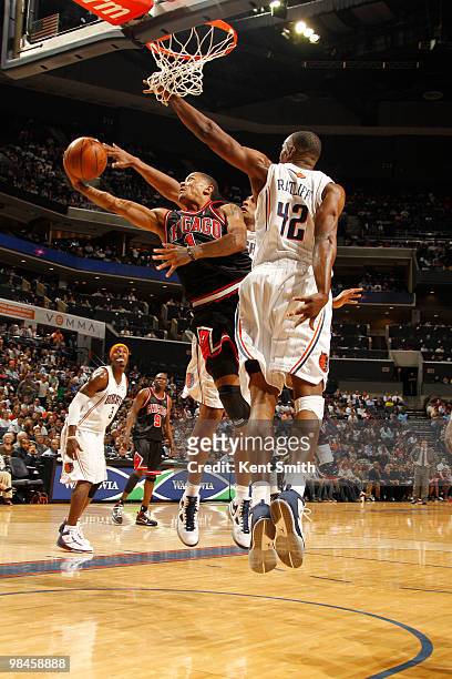 Boris Diaw of the Charlotte Bobcats on the block against Derrick Rose of the Chicago Bulls on April 14, 2010 at the Time Warner Cable Arena in...
