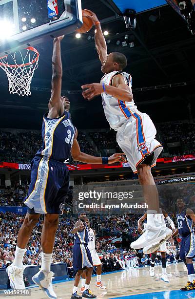 Russell Westbrook of the Oklahoma City Thunder dunks over Hasheem Thabeet of the Memphis Grizzlies on April 14, 2010 at the Ford Center in Oklahoma...