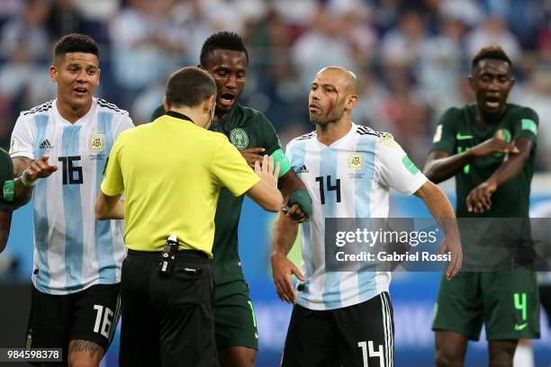 Javier Mascherano of Argentina and John Obi Mikel of Nigeria argue with Referee Cuneyt Cakir during the 2018 FIFA World Cup Russia group D match...