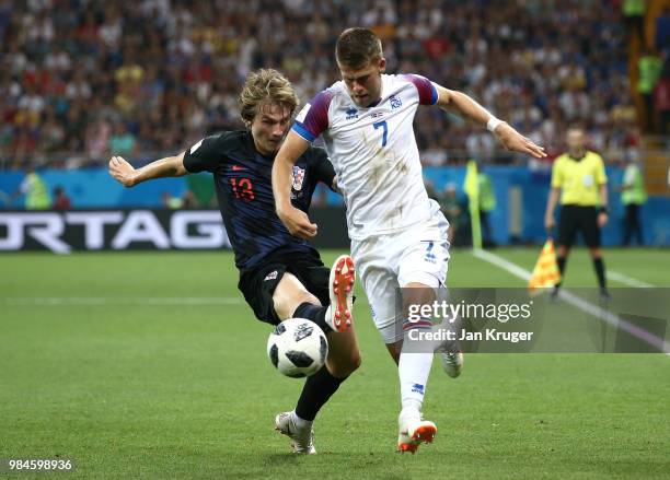 Johann Gudmundsson of Iceland is challenged by Tin Jedvaj of Croatia during the 2018 FIFA World Cup Russia group D match between Iceland and Croatia...