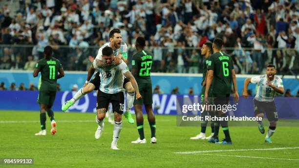 Marcos Rojo of Argentina celebrates after scoring his team's second goal with teammate Lionel Messi as Victor Moses, Kenneth Omeruo and Leon Balogun...