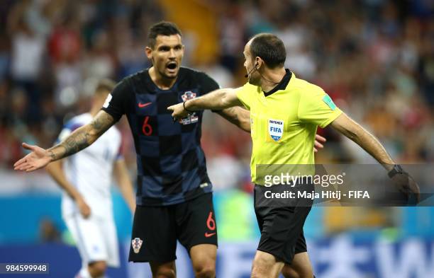Dejan Lovren of Croatia confronts referee Antonio Mateu after he awards Iceland a penalty for a Dejan Lovren of Croatia hand ball inside the penalty...