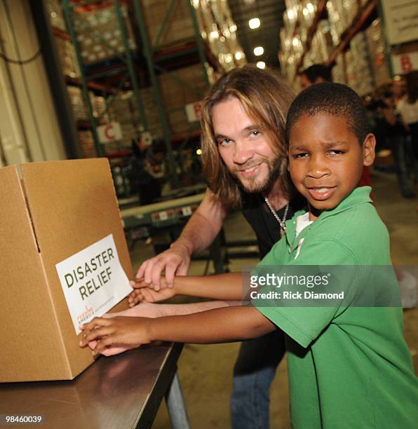 Former American Idol's Bo Bice and Volunteer participate in the "Idol Gives Back" Volunteer Program at the Second Harvest Food Bank of Middle...