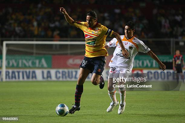 Morelia's Mauricio Romero fights for the ball with Alejandro Arguello of Jaguares in a 2010 Bicentenary Mexican Championship soccer match between...