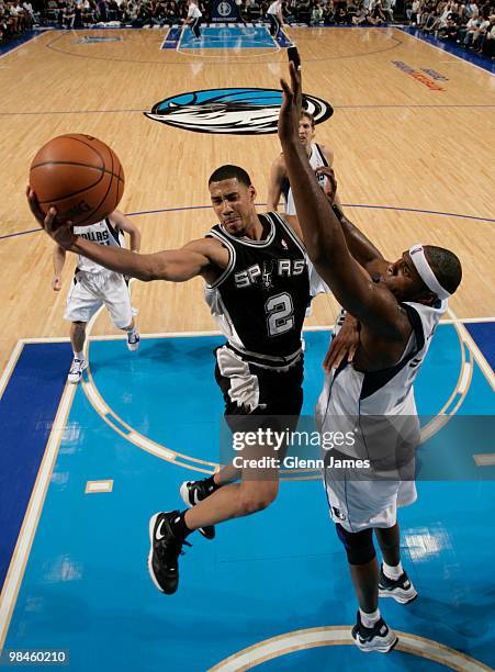 Garrett Temple of the San Antonio Spurs goes in for the layup against Brendan Haywood of the Dallas Mavericks during a game at the American Airlines...