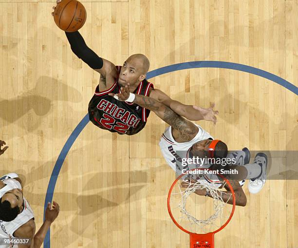 Taj Gibson of the Chicago Bulls dunks against Tyrus Thomas of the Charlotte Bobcats on April 14, 2010 at the Time Warner Cable Arena in Charlotte,...