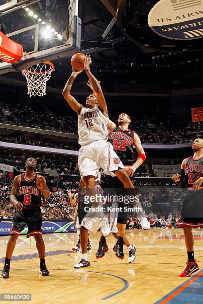 Tyrus Thomas of the Charlotte Bobcats goes for the layup against Brad Miller of the Chicago Bulls on April 14, 2010 at the Time Warner Cable Arena in...