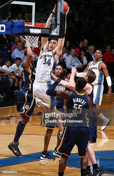 JaVale McGee of the Washington Wizards shoots against Danny Granger and Troy Murphy of the Indiana Pacers at the Verizon Center on April 14, 2010 in...