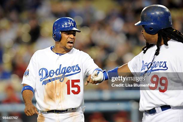 Rafael Furcal celebrates with teammate Manny Ramirez of the Los Angeles Dodgers after scoring in the first inning against the Arizona Diamondbacks at...