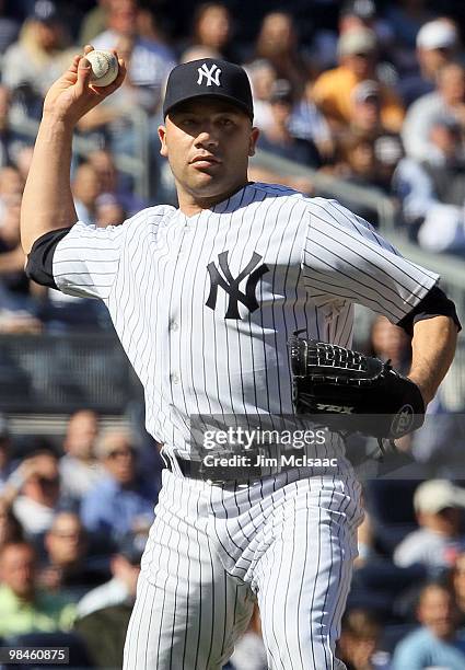 Alfredo Aceves of the New York Yankees throws to first base against the Los Angeles Angels of Anaheim on April 14, 2010 at Yankee Stadium in the...