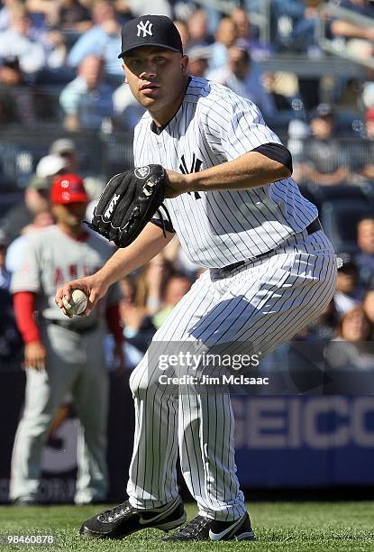 Alfredo Aceves of the New York Yankees throws to first base against the Los Angeles Angels of Anaheim on April 14, 2010 at Yankee Stadium in the...