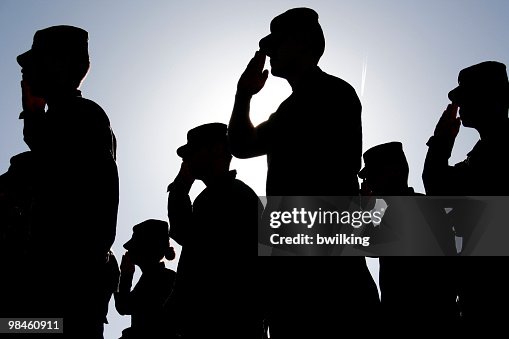 Soldiers Salute the Flag at Sunset