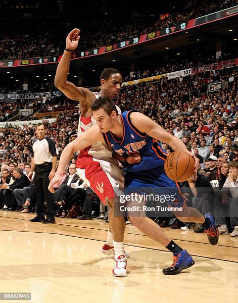 Danilo Gallinari of the New York Knicks drives baseline and gets around the tight defense of DeMar DeRozan of the Toronto Raptors during a game on...