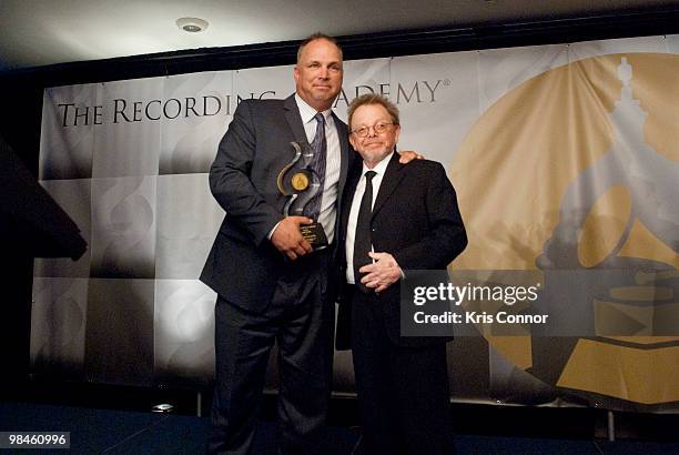 Garth Brooks and Paul Williams poses for photographers just after Brooks accepts The Solo Artist of the Century Award during the GRAMMYs on the Hill...