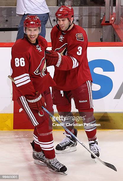 Wojtek Wolski of the Phoenix Coyotes celebrates with teammate Keith Yandle after Wolski scored a second-period power-play goal against the Detroit...