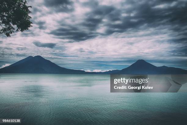 volcano atitlan and lake atitlan in guatemala. - lake atitlan stock pictures, royalty-free photos & images