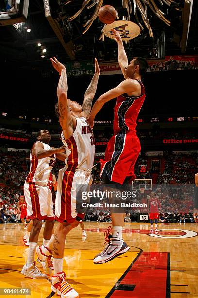 Yi Jianlian of the New Jersey Nets shoots against Michael Beasley of the Miami Heat on April 14, 2010 at American Airlines Arena in Miami, Florida....