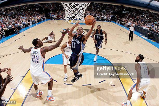 Mike Conley of the Memphis Grizzlies goes for the layup past Jeff Green of the Oklahoma City Thunder on April 14, 2010 at the Ford Center in Oklahoma...