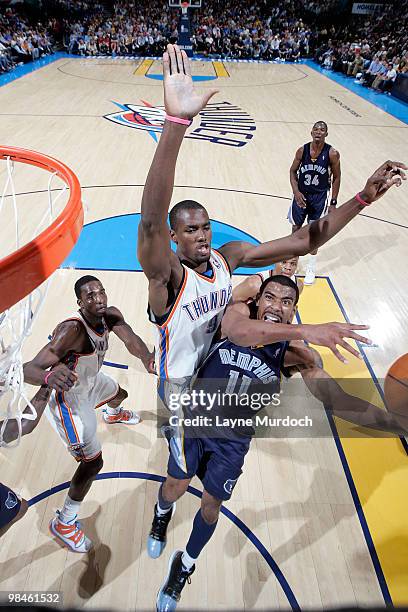 Mike Conley of the Memphis Grizzlies takes a shot past Serge Ibaka of the Oklahoma City Thunder on April 14, 2010 at the Ford Center in Oklahoma...