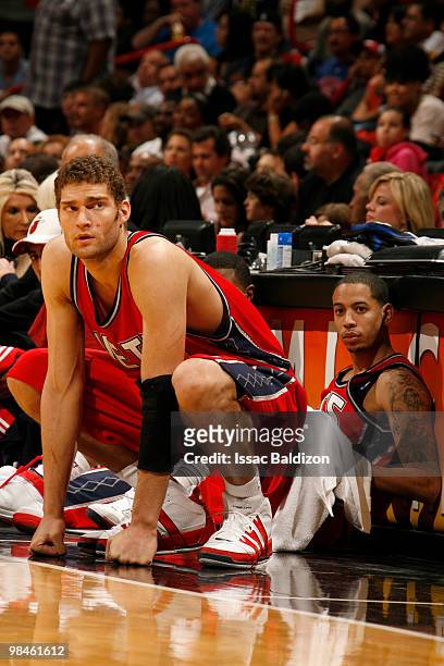 Devin Harris and Brook Lopez of the New Jersey Nets take a breather against the Miami Heat on April 14, 2010 at American Airlines Arena in Miami,...
