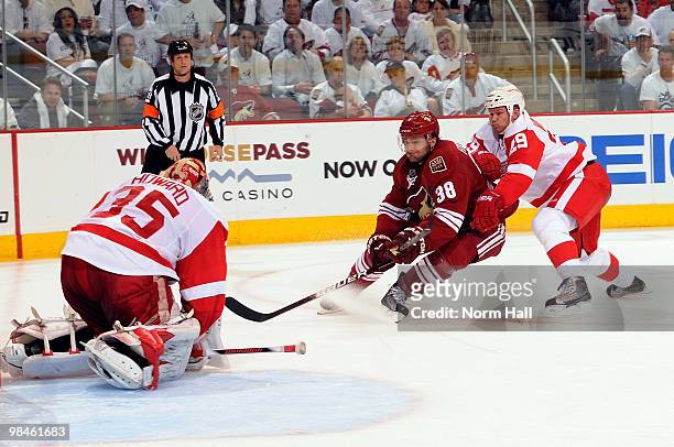Jason Williams of the Detroit Red Wings tries to prevent Vernon Fiddler of the Phoenix Coyotes from scoring on Jimmy Howard of the Detroit Red Wings...