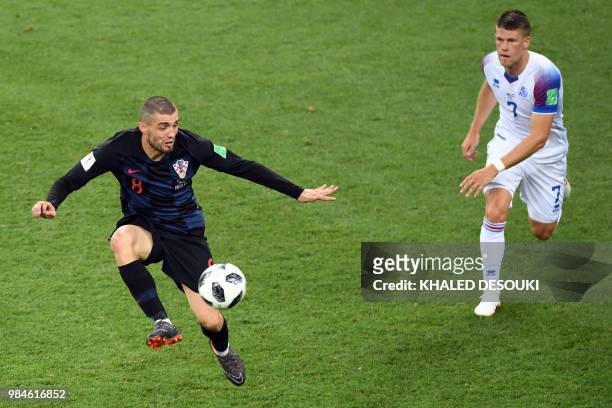 Croatia's midfielder Mateo Kovacic challenges Iceland's midfielder Johann Gudmundsson during the Russia 2018 World Cup Group D football match between...