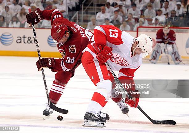 Vernon Fiddler of the Phoenix Coyotes and Pavel Datsyuk of the Detroit Red Wings fight for control of a face off in Game One of the Western...