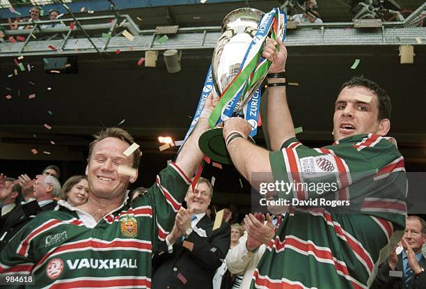 Captain Martin Johnson and Pat Howard of Leicester celebrates winning the Championship Trophy during the match between Bath and Leicester Tigers in...