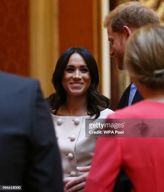 Meghan, Duchess of Sussex and Prince Harry, Duke of Sussex meet group of leaders during the Queen's Young Leaders Awards Ceremony at Buckingham...