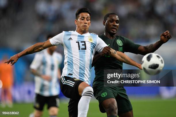 Argentina's midfielder Maximiliano Meza vies for the ball with Nigeria's forward Odion Jude Ighalo during the Russia 2018 World Cup Group D football...