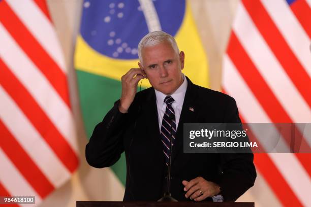 Vice President Mike Pence gestures during a press statement with Brazilian President Michel Temer at Itamaray Palace in Brasilia, on June 26, 2018. -...