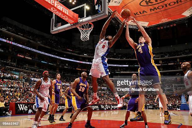 DeAndre Jordan of the Los Angeles Clippers reaches for a rebound against Luke Walton of the Los Angeles Lakers at Staples Center on April 14, 2010 in...