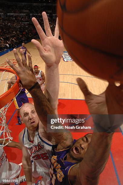 Chris Kaman of the Los Angeles Clippers challenges the shot of Josh Powell of the Los Angeles Lakers at Staples Center on April 14, 2010 in Los...