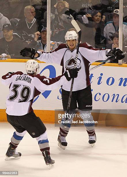 Chris Stewart of the Colorado Avalanche celebrates with teammate T.J. Galiardi after scoring the game winning goal against the San Jose Sharks in...