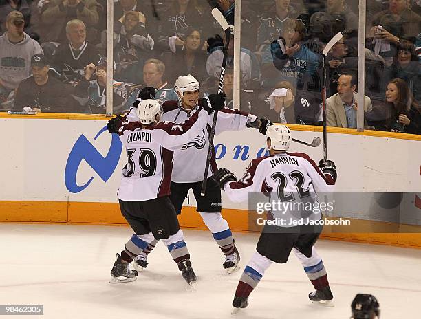 Chris Stewart of the Colorado Avalanche celebrates with teammate T.J. Galiardi and Scott Hannan after scoring the game winning goal against the San...