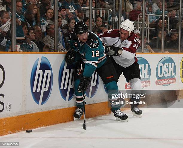 Milan Hejduk of the Colorado Avalanche battles along the boards with Patrick Marleau of the San Jose Sharks in Game One of the Western Conference...