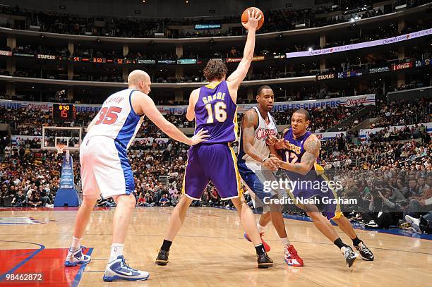 Pau Gasol of the Los Angeles Lakers holds the ball while teammate Shannon Brown makes his way around Rasual Butler of the Los Angeles Clippers at...