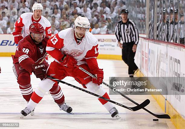 Pavel Datsyuk of the Detroit Red Wings skates with the puck past Vernon Fiddler of the Phoenix Coyotes in Game One of the Western Conference...
