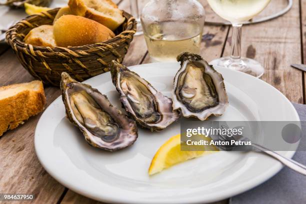 fresh oysters with lemon, bread and butter - arcachon stock-fotos und bilder