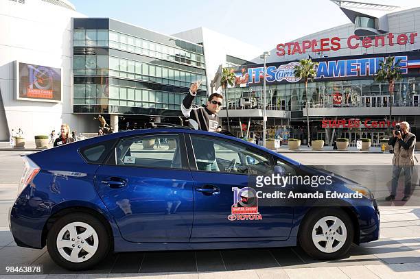 Gabe Reyes poses in the 2010 Toyota Prius he won in a raffle after the Staples Center's 10 Greatest Moments were revealed during a press conference...