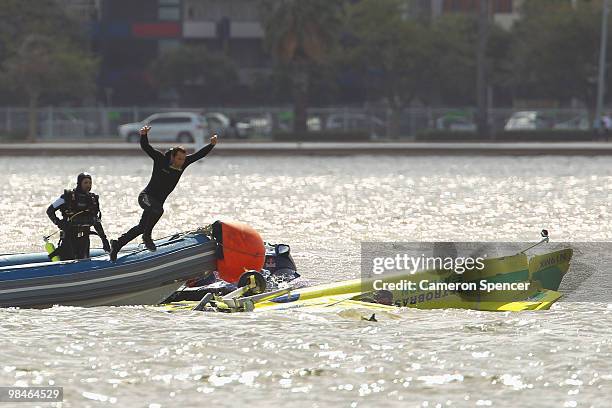 Adilson Kindlemann of Brazil crashes into the Swan River as Emergency Services rush to his aid during the Red Bull Air Race Training day on April 15,...