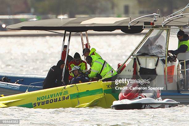 Adilson Kindlemann of Brazil crashes into the Swan River as Emergency Services rush to his aid during the Red Bull Air Race Training day on April 15,...