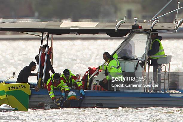 Adilson Kindlemann of Brazil crashes into the Swan River as Emergency Services rush to his aid during the Red Bull Air Race Training day on April 15,...